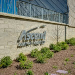 metal Ascend Amphitheatre logo on brick wall